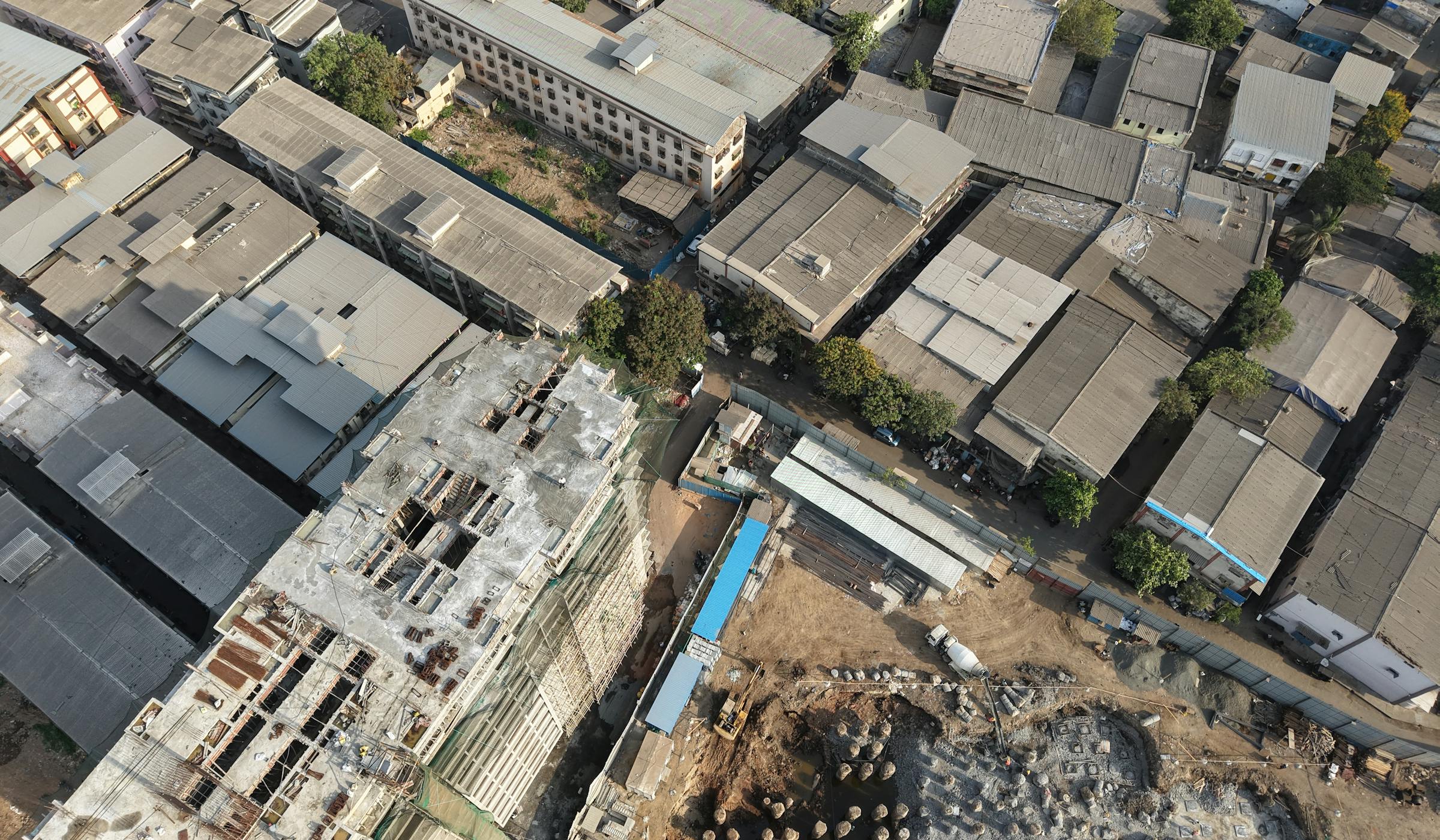 Aerial view of a Mumbai construction site amid dense industrial neighbourhoods
