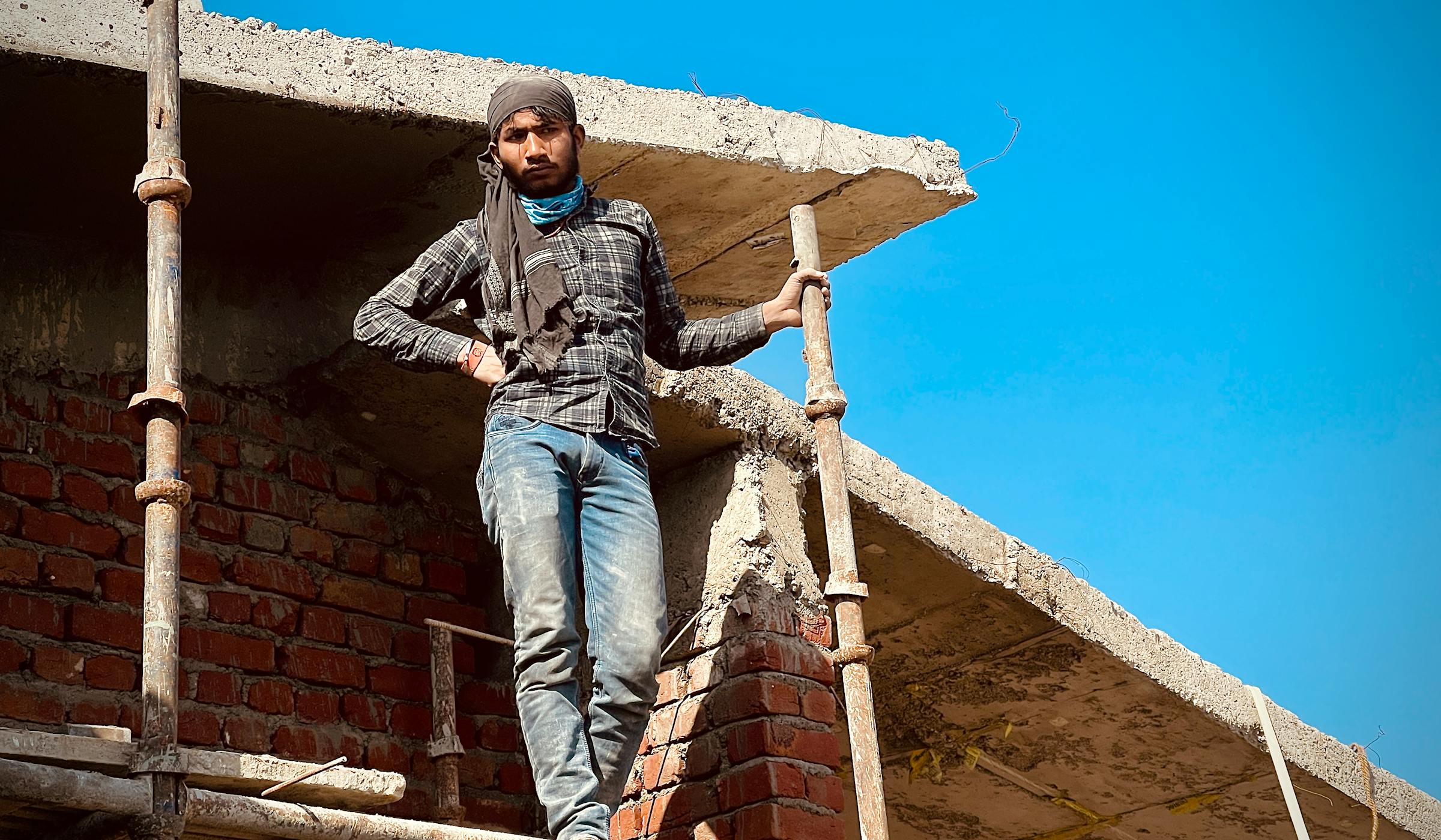Construction worker on scaffolding at an Indian high-rise project